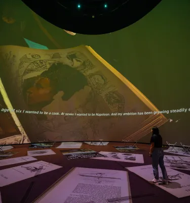 Dome projection with woman in front of it 