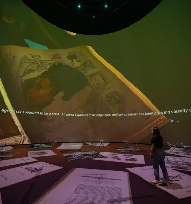 Dome projection with woman in front of it 