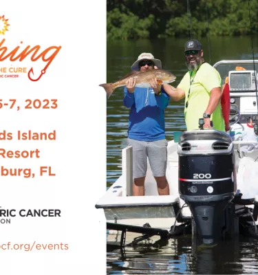 Three adults on a small boat in the water with a woman holding up a fish she caught.