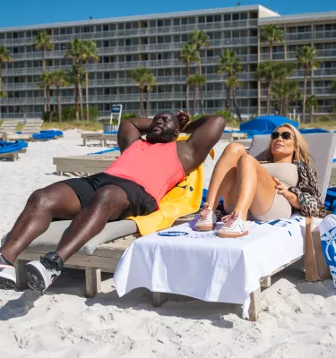 WWE wrestlers laying in beach chairs