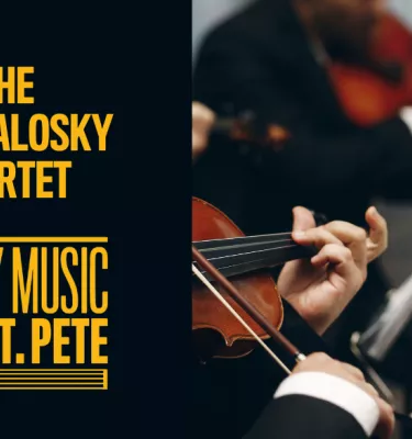 Image of two people reading sheet music and playing violins.