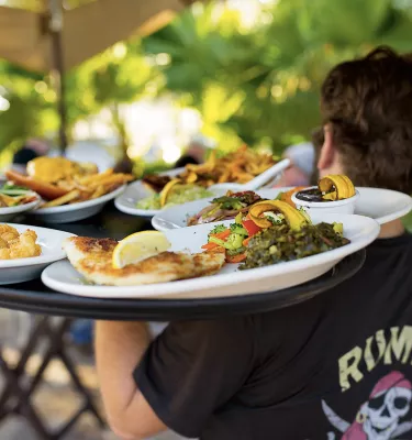 server holding tray of food