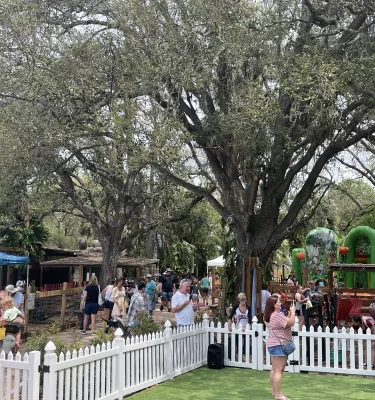 Image of an Easter Festival at an outside farm with various groups of people engaging in different activities.