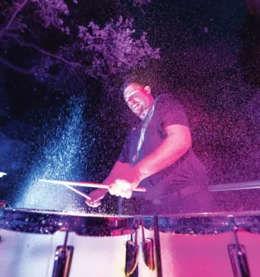 Man playing drums at night at Busch Gardens in Tampa.