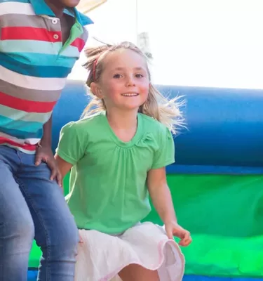 Kids jumping in a bounce house.