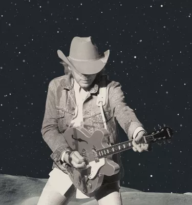 Dwight Yoakam singer-songwriter playing guitar.
