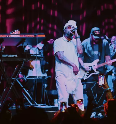 American rapper Juvenile on stage with his band.