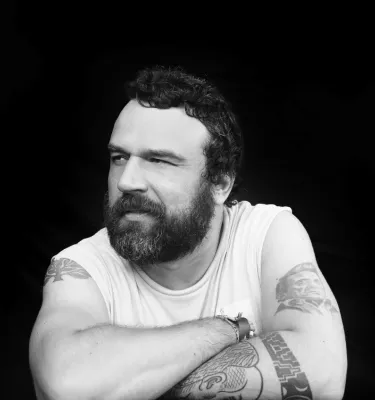 Male music artist headshot in black and white.