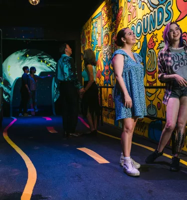 two women walk through a FLoridaRAMA exhibit