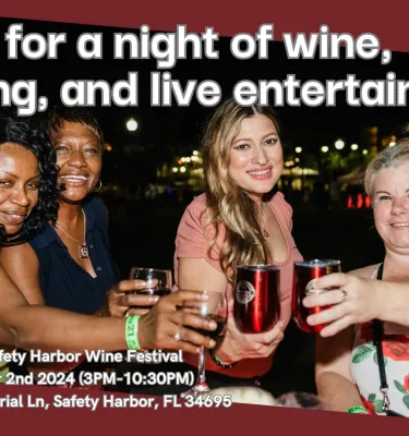 Safety Harbor Wine Festival featuring 4 women holding up their drinks and smiling at the camera.