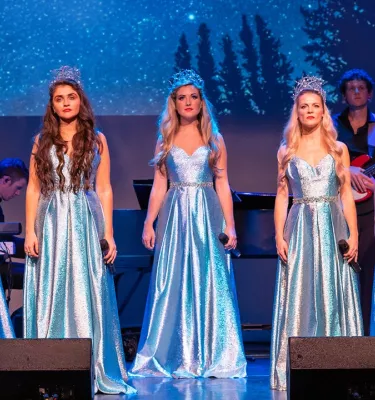 Celtic Christmas Angels show in Clearwater, FL featuring five woman dressed up in silver gowns on stage.