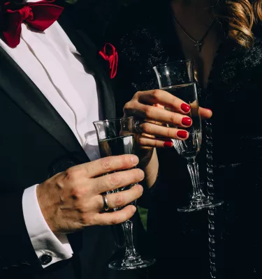 New Years Eve holiday party featuring a couple holding glasses of sparkling wine.