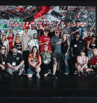 Group of adults posing in the OCC Roadhouse & Bike Museum in Clearwater, FL.