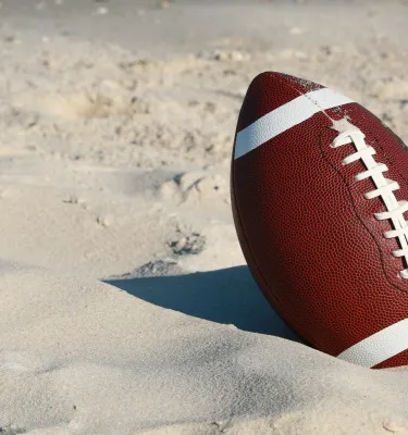 Stock shot of a football on the beach