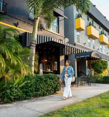 girl walking in front of hotel