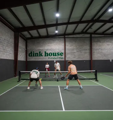 people playing pickleball on an indoor court