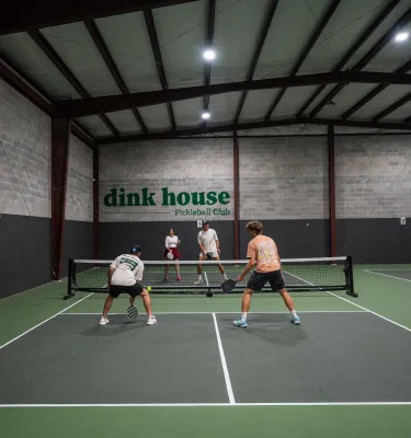 people playing pickleball on an indoor court