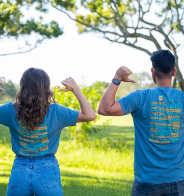 two people standing with backs turned