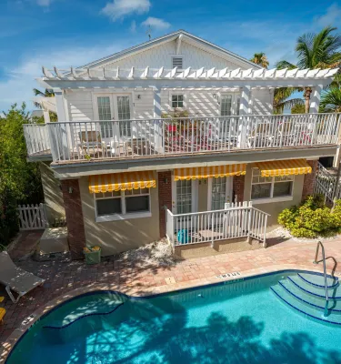 a view of the pool and the balcony above it at Coconut Inn in Pass-a-Grille