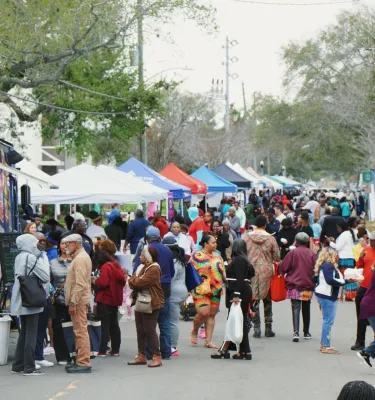 Tampa Bay Collard Green Festival outside featuring shoppers and vendor tents.
