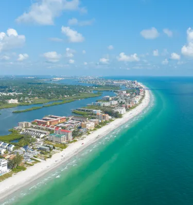 drone shot of the beach with emerald green water