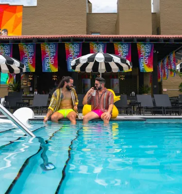 two men sitting on the edge of the pool at The Wet Spot next to the Mari Jean Hotel in St. Pete