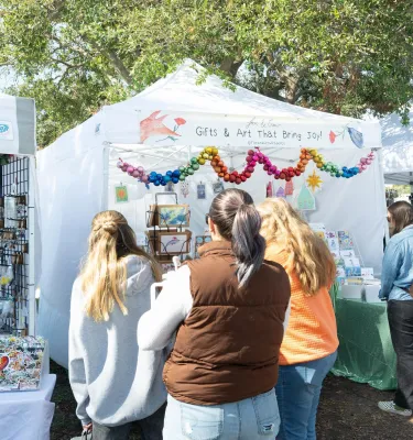 shoppers browsing vendor kiosks at Shopapalooza in St. Pete