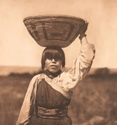 Brown and white drawing of a Native American with a basket above their head.