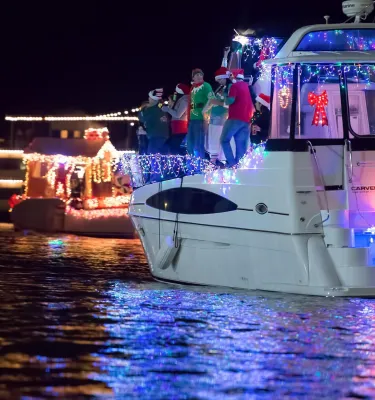 boats decorated for a nighttime holiday boat parade