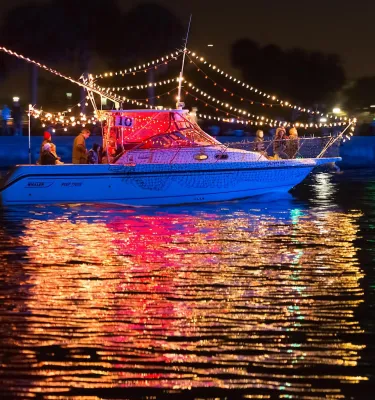 a boat lit up with holiday lights for the St. Pete holiday boat parade