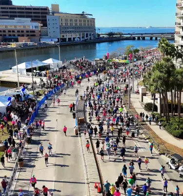 an aerial image of many runners near the Tampa waterfront in the Gasparilla Distance Classic