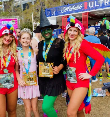 runners dressed in fun costumes at a party after a running race in the Gasparilla Distance Classic