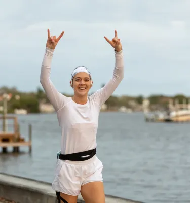 a young woman runs next to Coffee Pot Bayou during the St. Petersburg Distance Classic