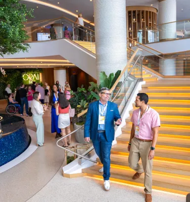 People walking down stairs of a hotel