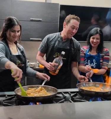 Chef teaching a cooking class to participants.