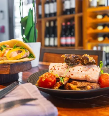 a fish dish served next to soft tacos at the bar at Bin 6 South in St. Petersburg