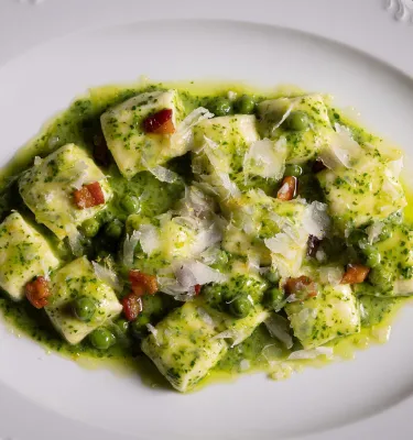 a plate of gnocchi in a creamy spinach sauce at Elliott Aster at the Vinoy Resort and Golf Club