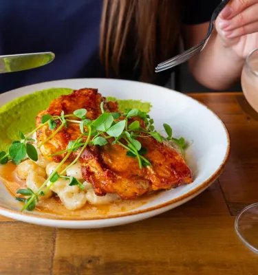 a person about to dig into a plate of food at Little Lamb Gastropub in Clearwater