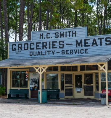 A historic general store building surrounded by trees at Heritage Village in Largo, Florida.