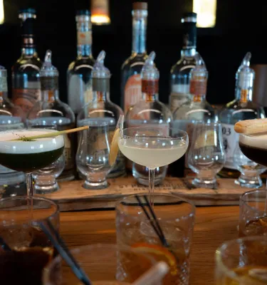 Distillery tour featuring a table of martinis and spirits.