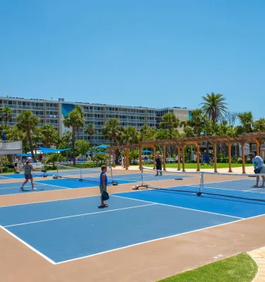 people playing pickleball on outdoor courts at TradeWinds Resort