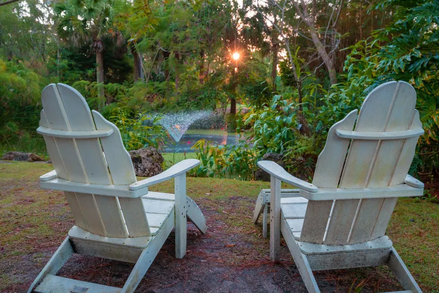 Adirondack chairs facing the fountain at Florida Botanical Gardens