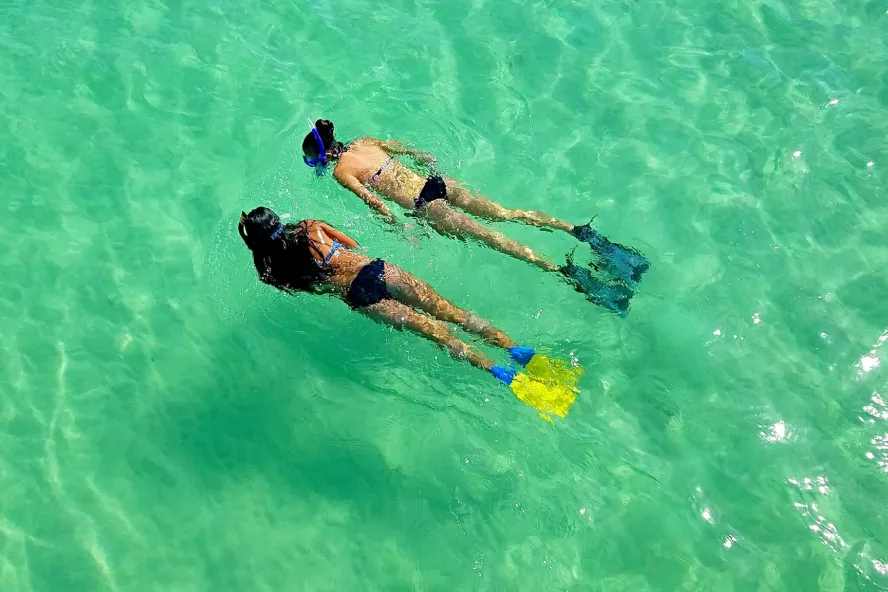 Two girls snorkeling in the emerald waters off Egmont Key