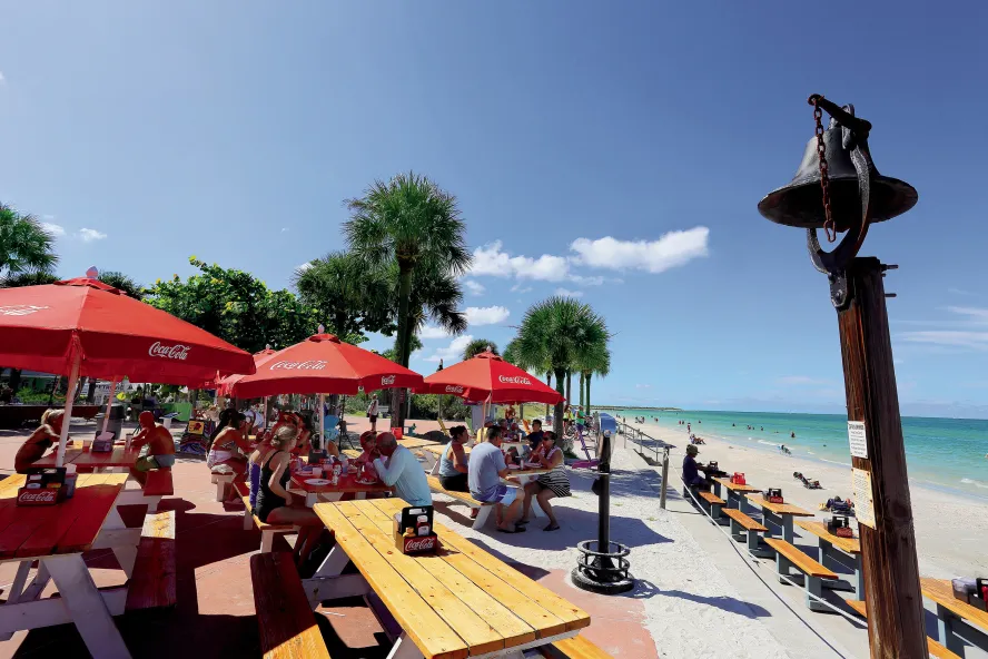 People outside dining at Paradise Grille, which overlooks Pass-A-Grille beach