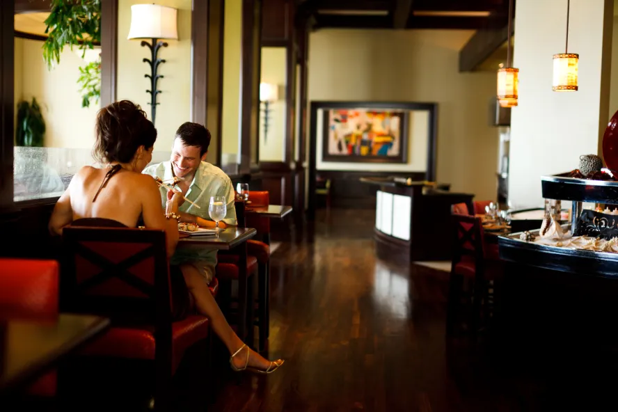 A couple enjoying a meal in an indoor setting of Caretta restaurant.