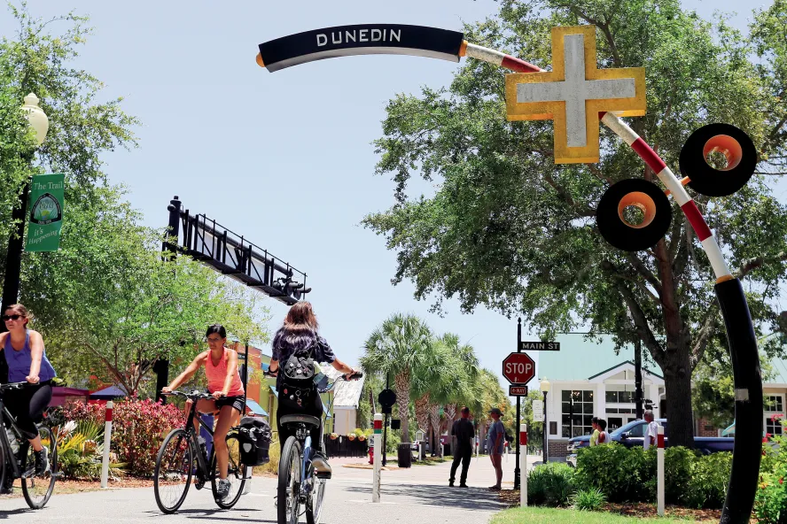 Bikers at Pinellas Trail crossing Dunedin's Main St.