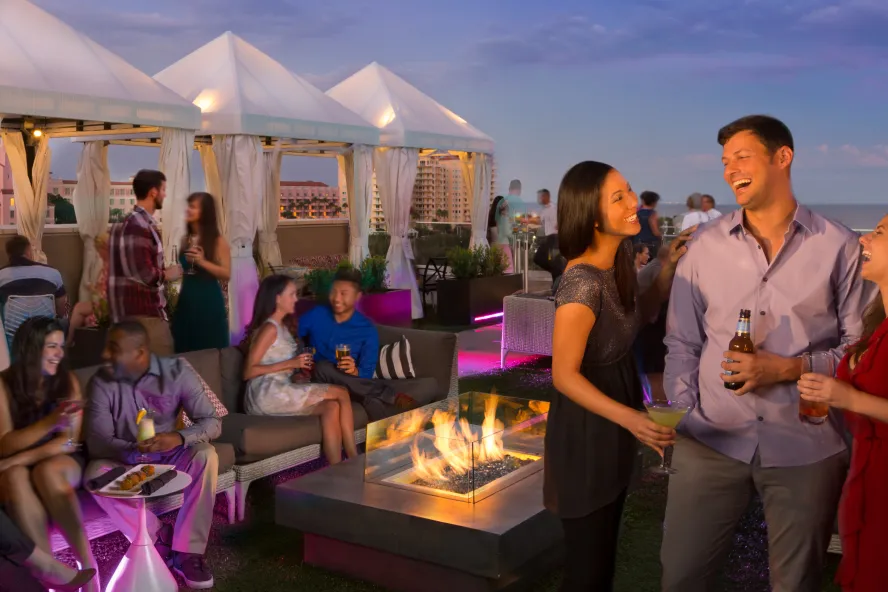 Several people enjoying drinks at The Canopy rooftop in St. Pete