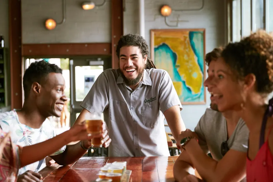A group of friends enjoying drinks at Green Bench Brewery in St. Pete