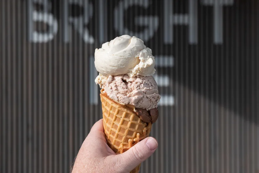 An ice cream cone in front of the Bright Ice Sign at their storefront in Pinellas Park
