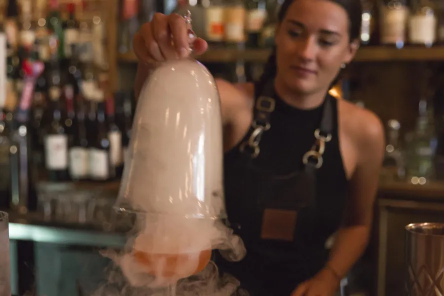 A bartender serves a Smokey cocktail at Mandrin Hide on Central Ave in downtown St. Pete